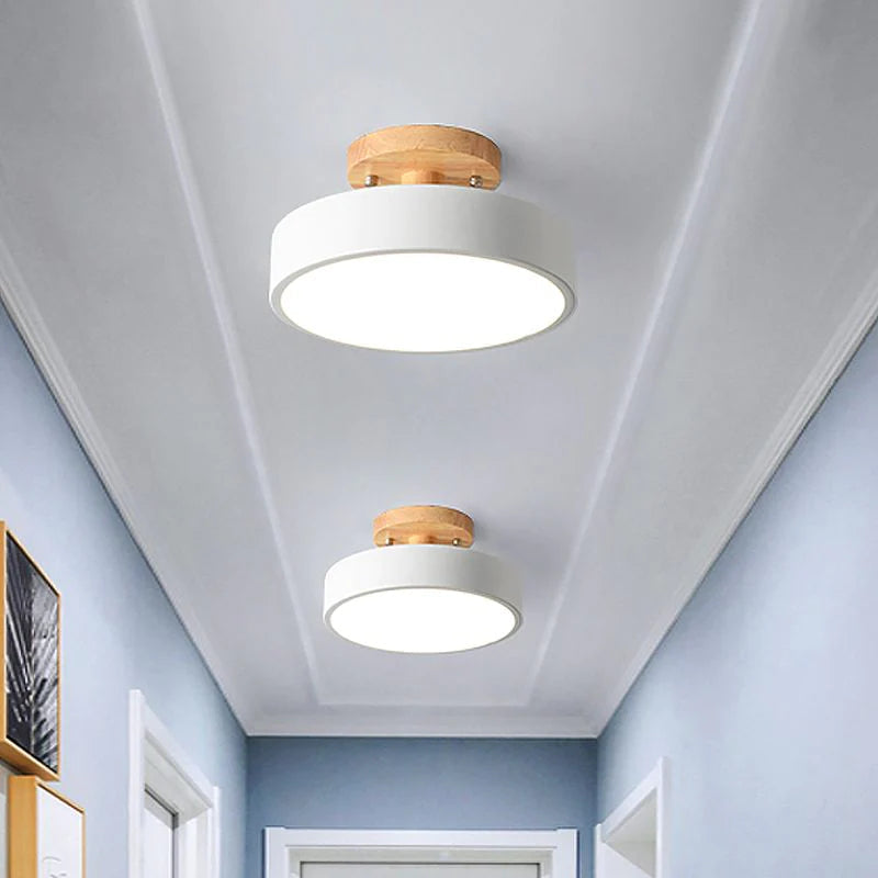 Two crisp white Nordic macaron huty ceiling lights contrasting beautifully in a light blue hallway