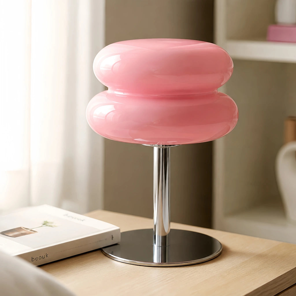 Soft pink hutyl glass macaron desk lamp resting gracefully on a minimal wooden table