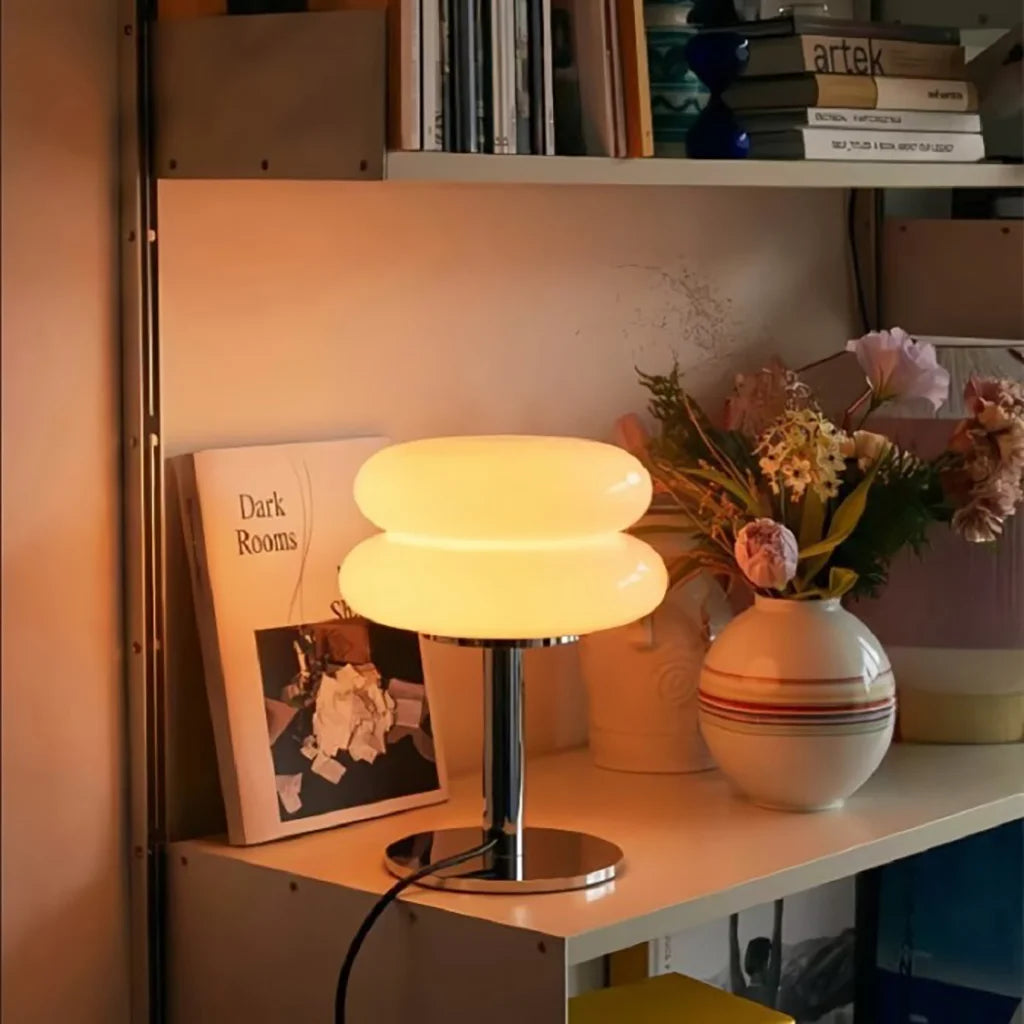retro hutyl glass table lamp providing cosy, warm illumination on a styled bookshelf