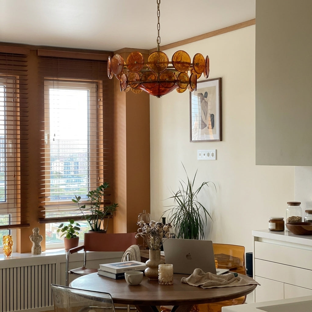 Joltly amber glass disc chandelier hanging in a dining area beside a window
