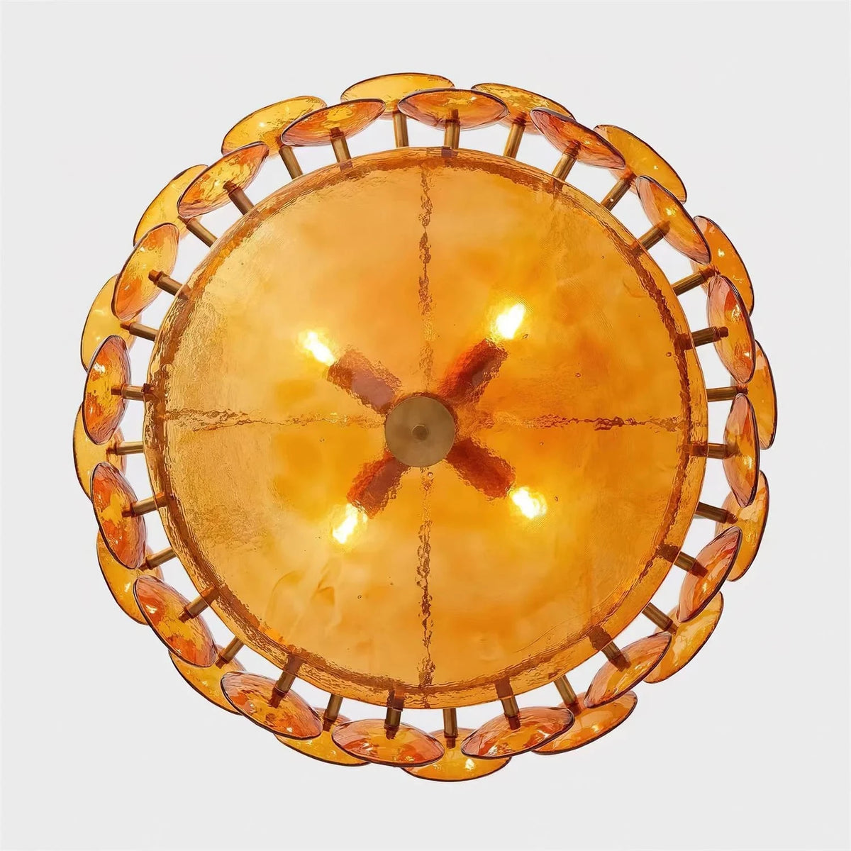 Joltly amber glass disc chandelier lit, seen from below