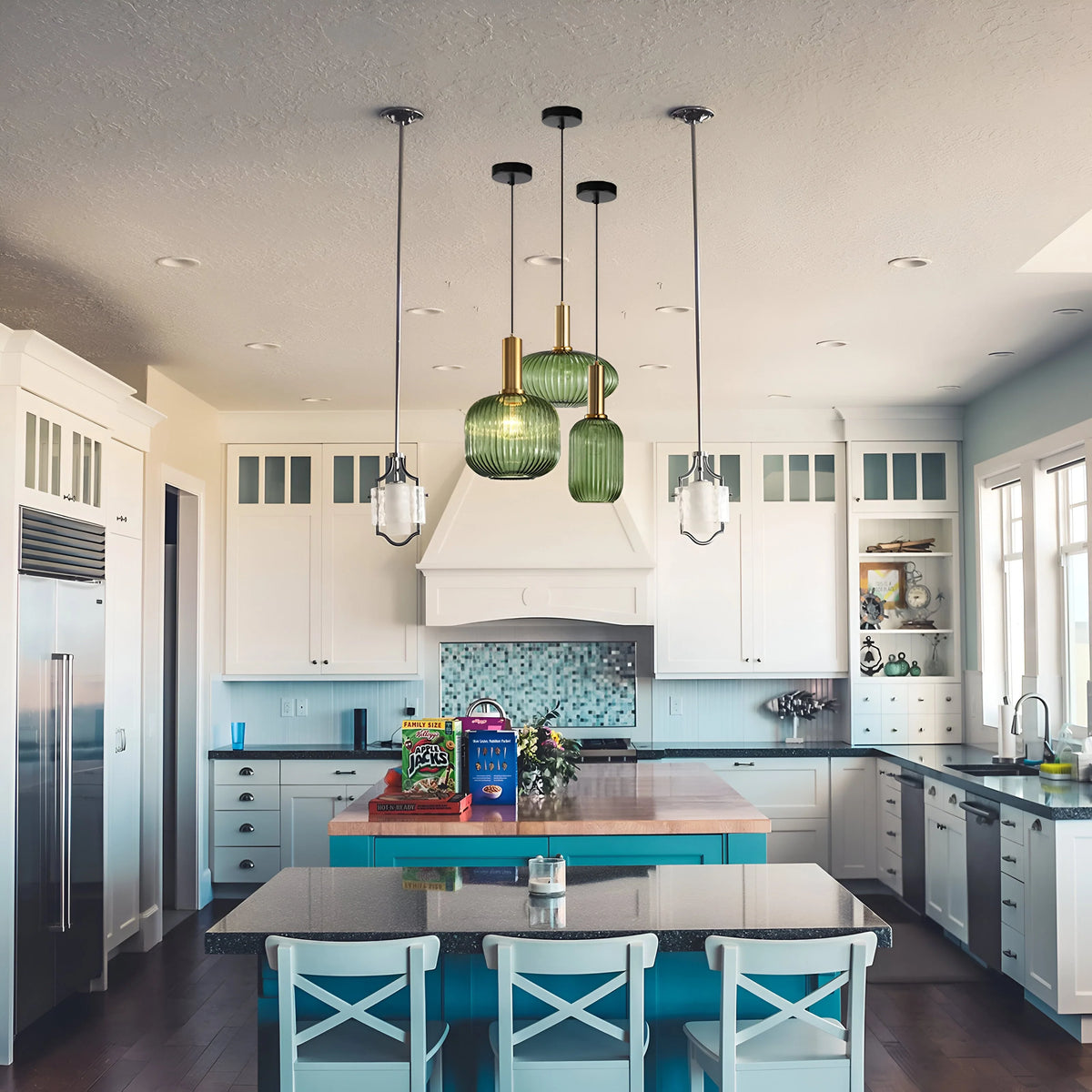 Green ribbed glass pendant lights hanging above a kitchen island in a white kitchen
