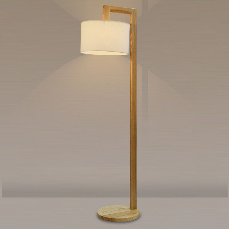Illuminated minimalist wood kelta floor lamp highlighting its clean architectural lines and warm light