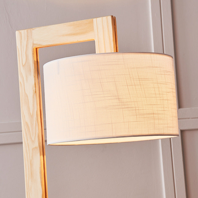 Close-up detail of the kelta solid light wood right-angle joint and textured beige fabric lampshade