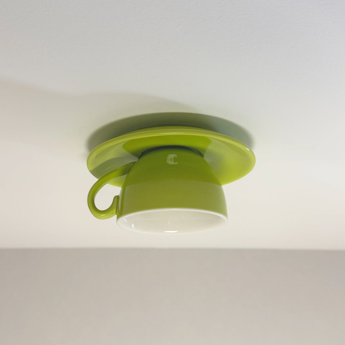 Light green playful coffee cup kupce ceiling fixture mounted flush against a ceiling