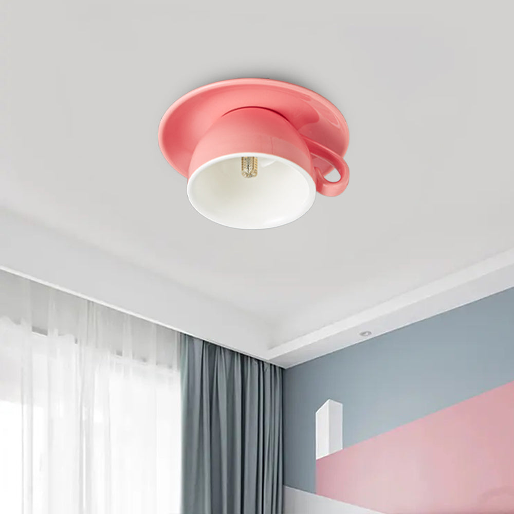 Pink ceramic teacup kupce ceiling light adding a whimsical, colourful touch to a modern bedroom