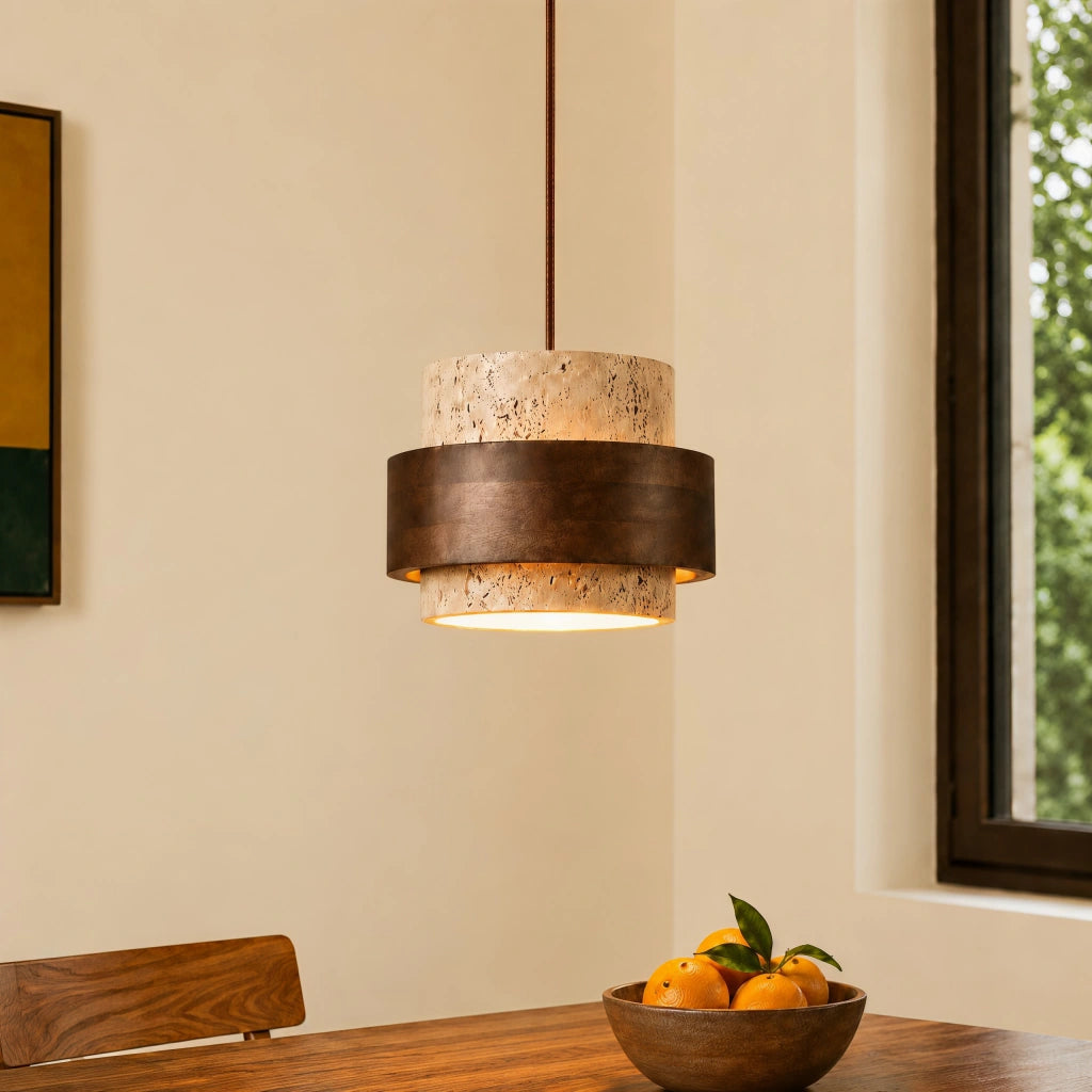 Single kyra Japandi travertine stone pendant light with a dark wood band hanging over a dining table