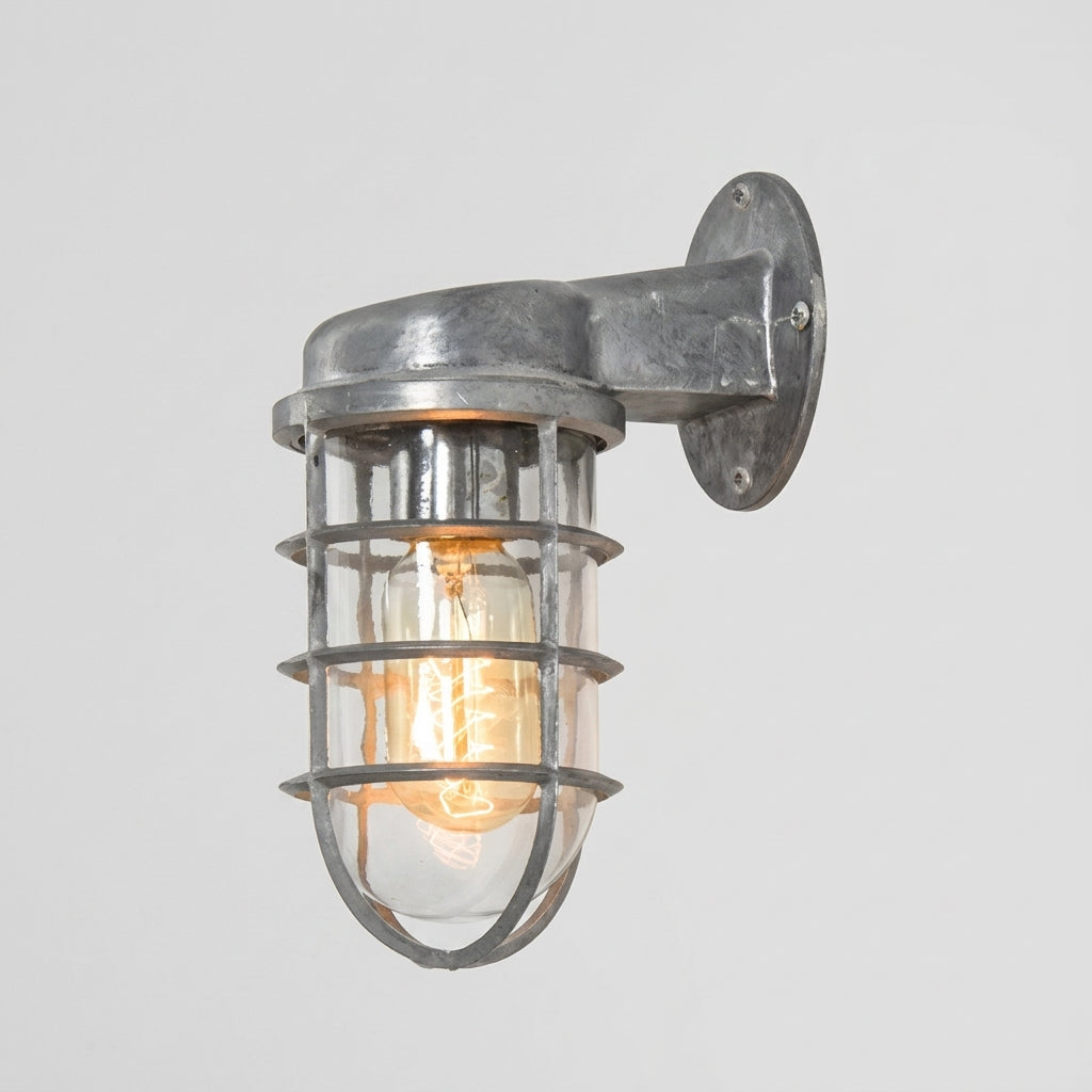 Laze silver cage guard bulkhead wall light lit on a light grey background