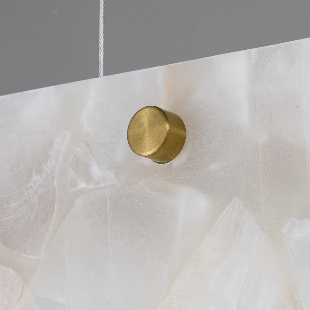 Levon alabaster linear chandelier brass end cap on natural alabaster, close-up