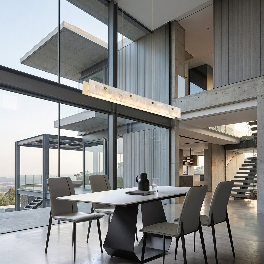 Levon alabaster linear chandelier in a concrete and glass atrium with floor-to-ceiling windows