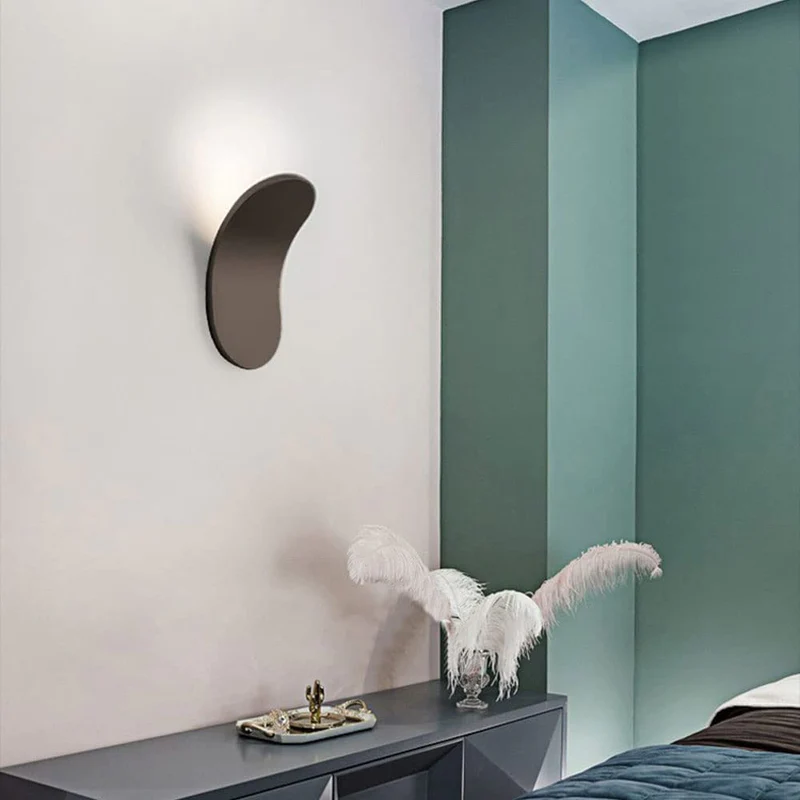 Brown architectural lexi wall sconce installed on a light wall next to a teal accent wall
