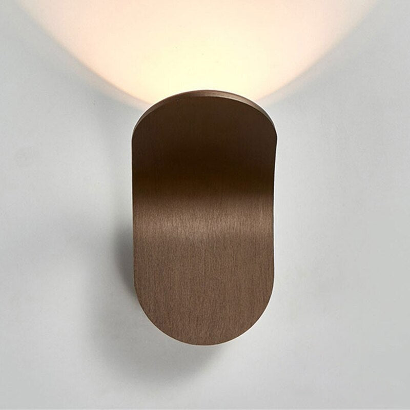 Front profile view of the sleek brown Nordic curved lexi wall sconce.