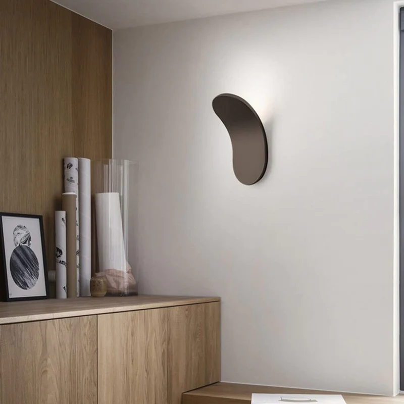Minimalist lexi brown wall light illuminating a modern space with wooden cabinetry