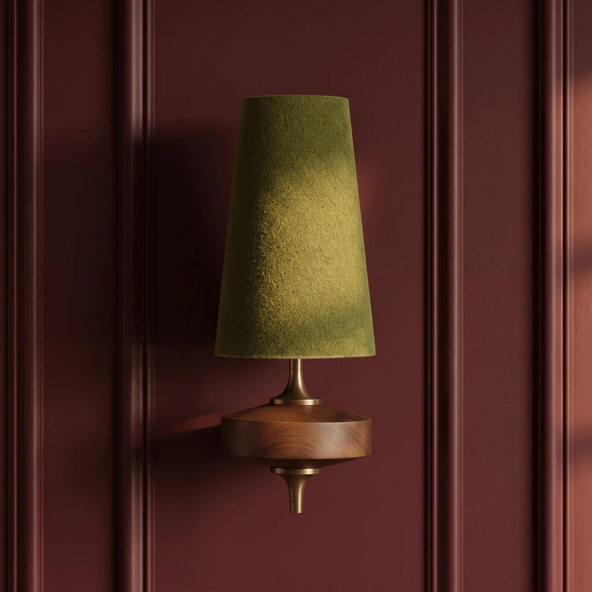 Close-up of the Lisk green fabric shade wall light on an oxblood panelled wall