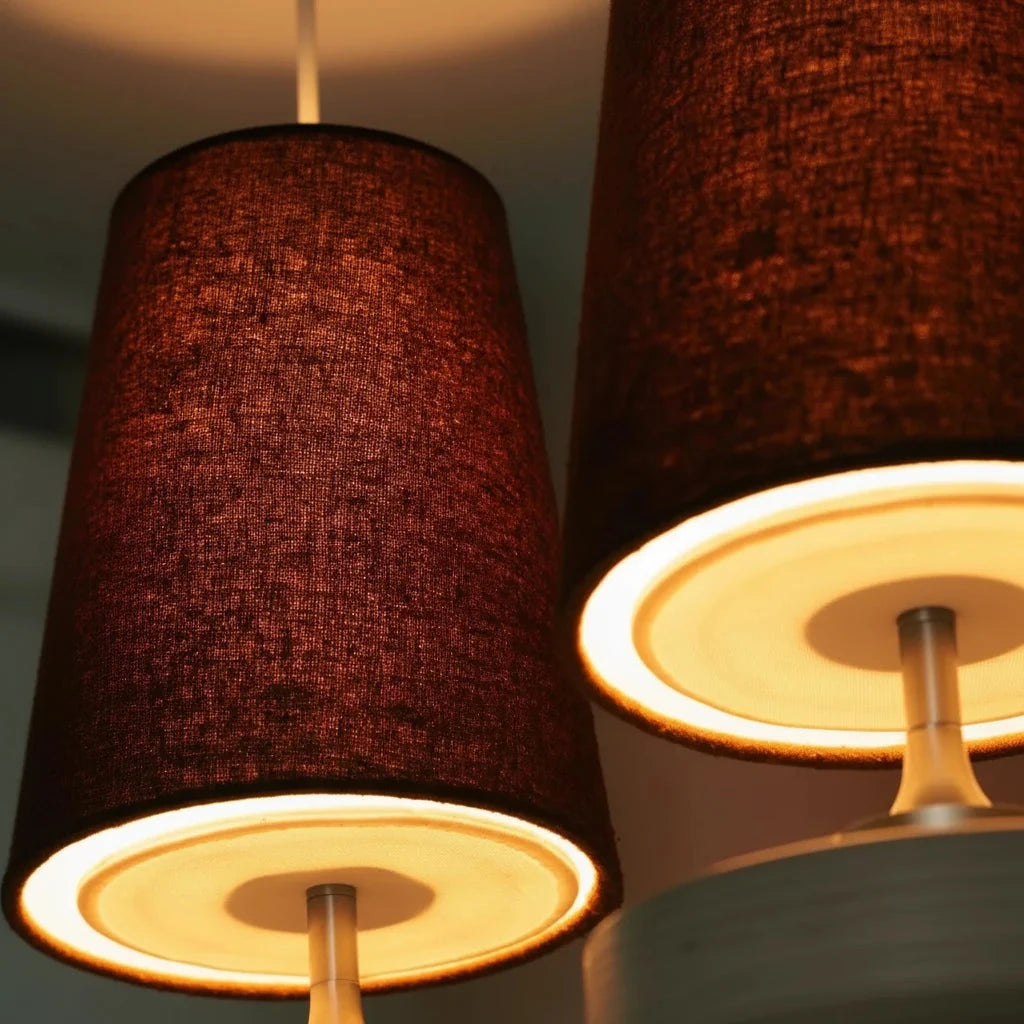 Close-up of the Lisk red fabric shades glowing warmly from below