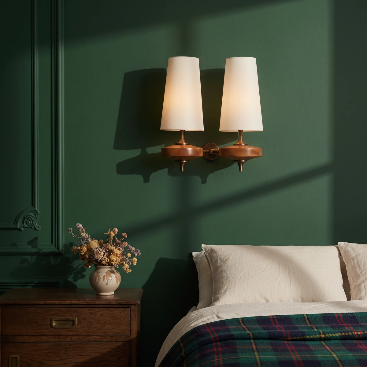 Lisk white 2-head fabric shade wall light on a racing green wall above a bed with a tartan blanket