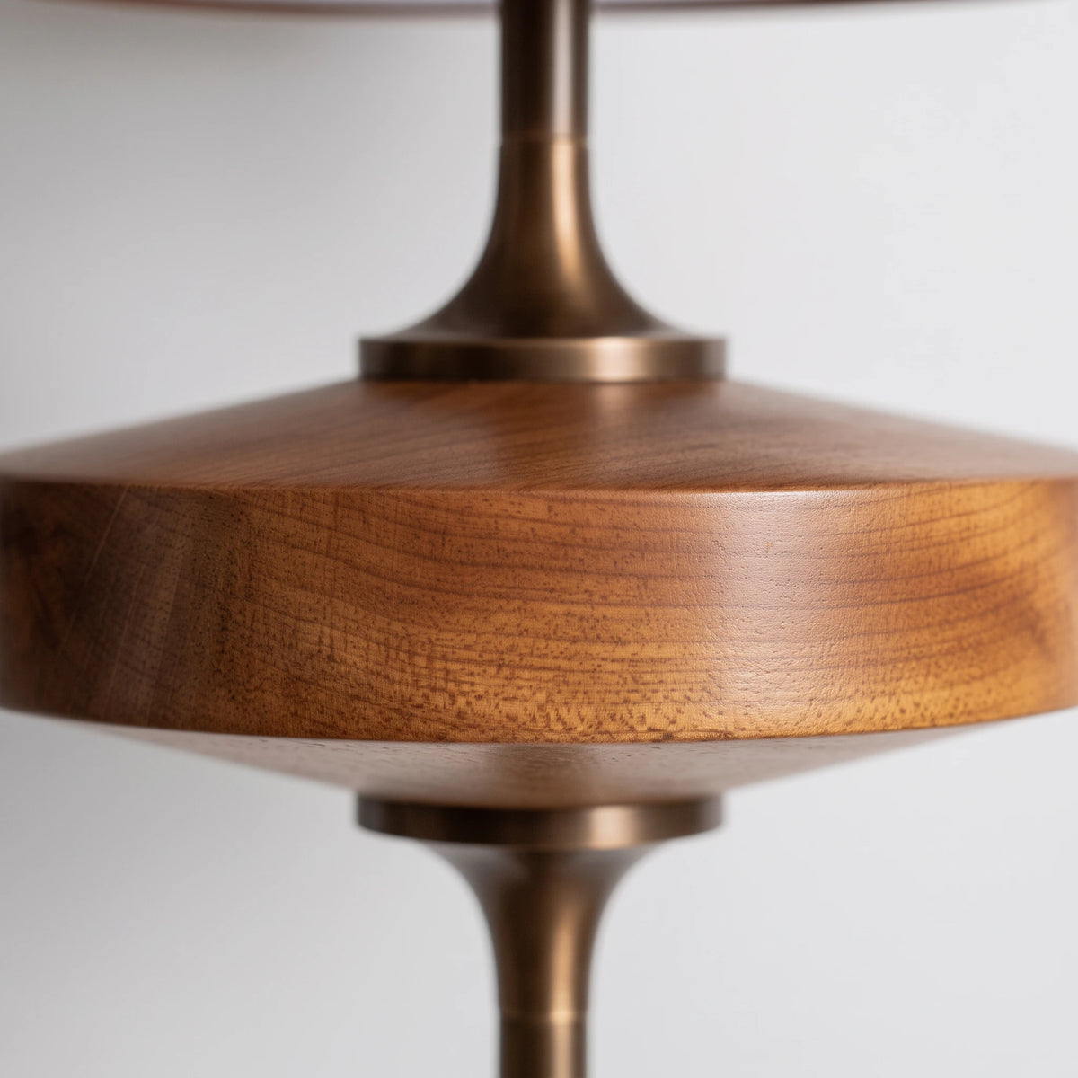 Close-up of the Lisk wooden base and antique brass-finish stem