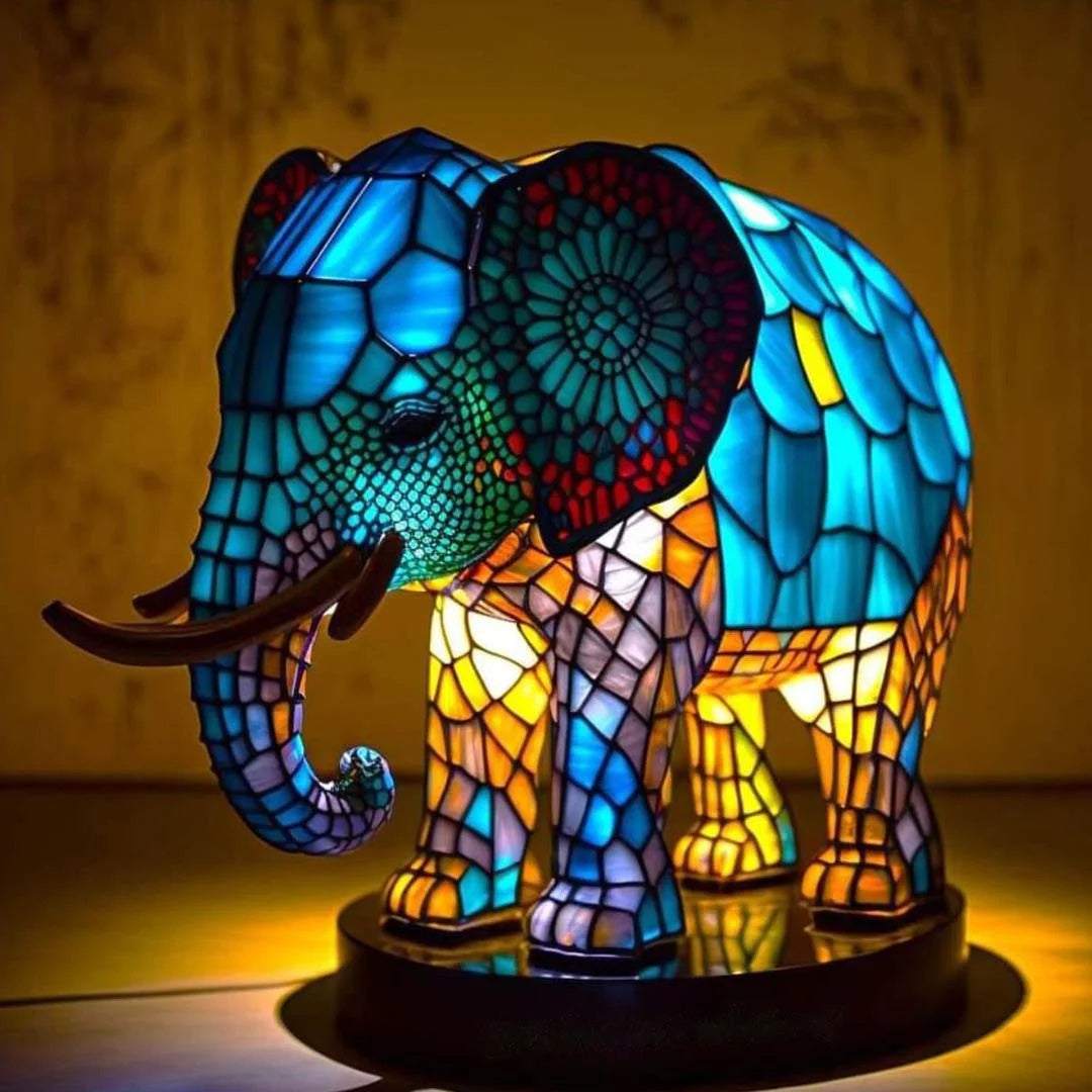 Stained glass effect lopi elephant nightlight glowing brightly against a dark background