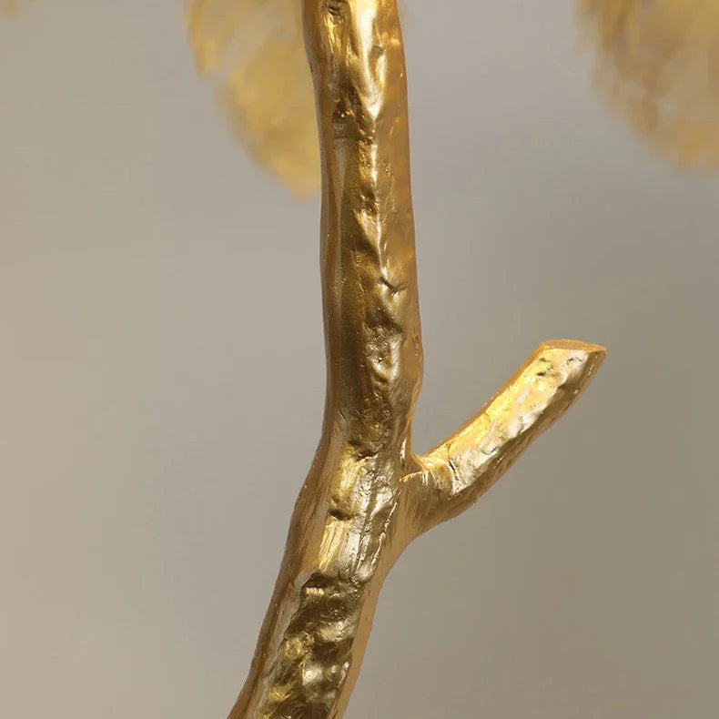 Close-up of the textured gold branch stem of the Lorne feather lamp