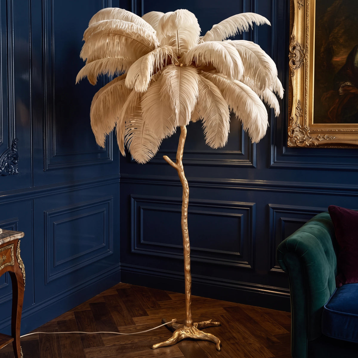 Lorne khaki ostrich feather floor lamp in a navy panelled corner with a gilt-framed painting and herringbone floor
