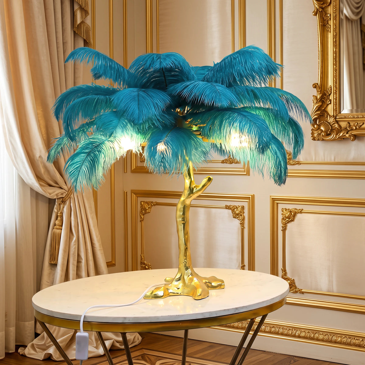 Lorne peacock blue ostrich feather lamp with a gold branch base on a marble side table against an ivory panelled wall