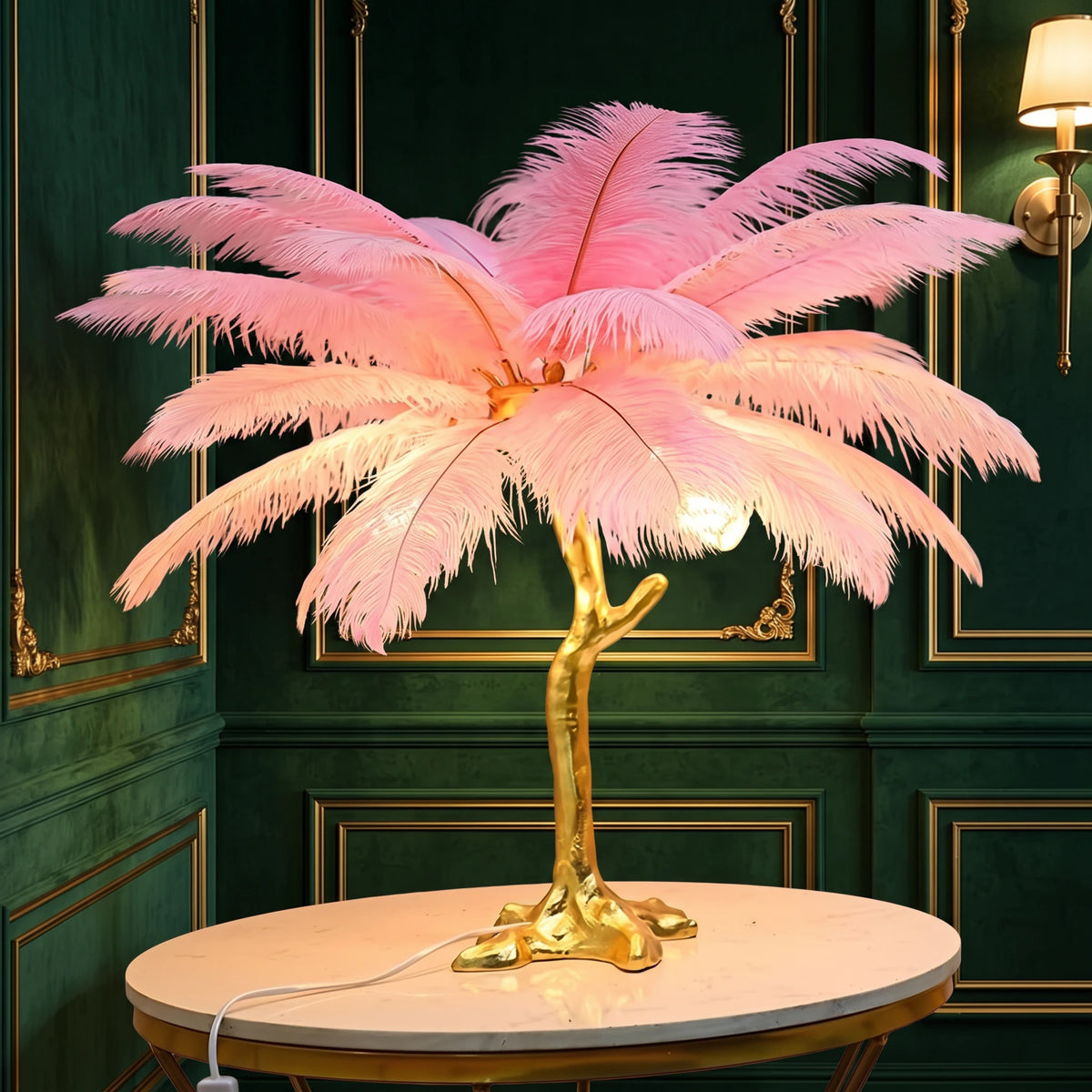 Lorne purple ostrich feather lamp with a gold branch base on a marble side table against a green panelled wall