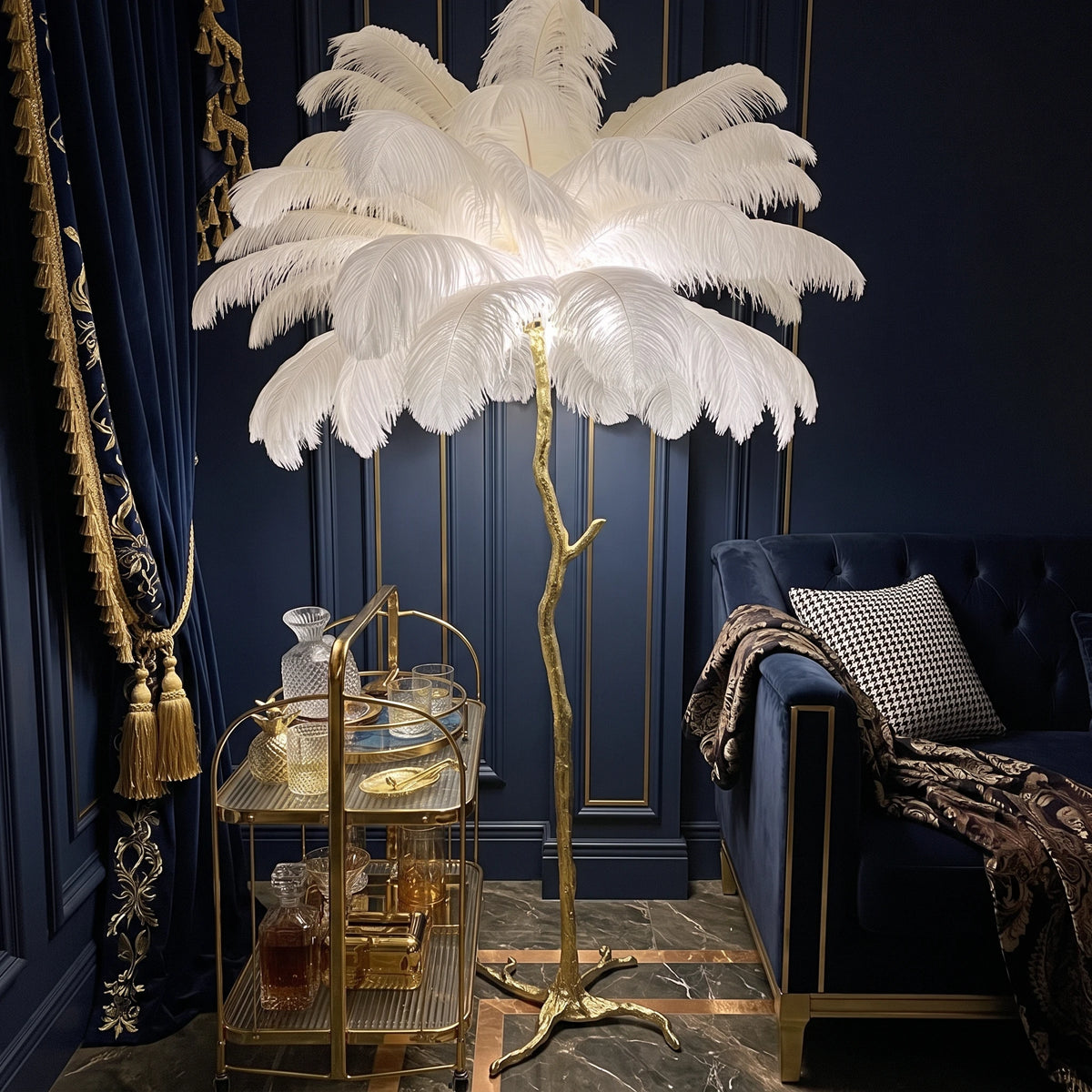 Lorne white ostrich feather floor lamp in a navy lounge with a brass drinks trolley and velvet sofa
