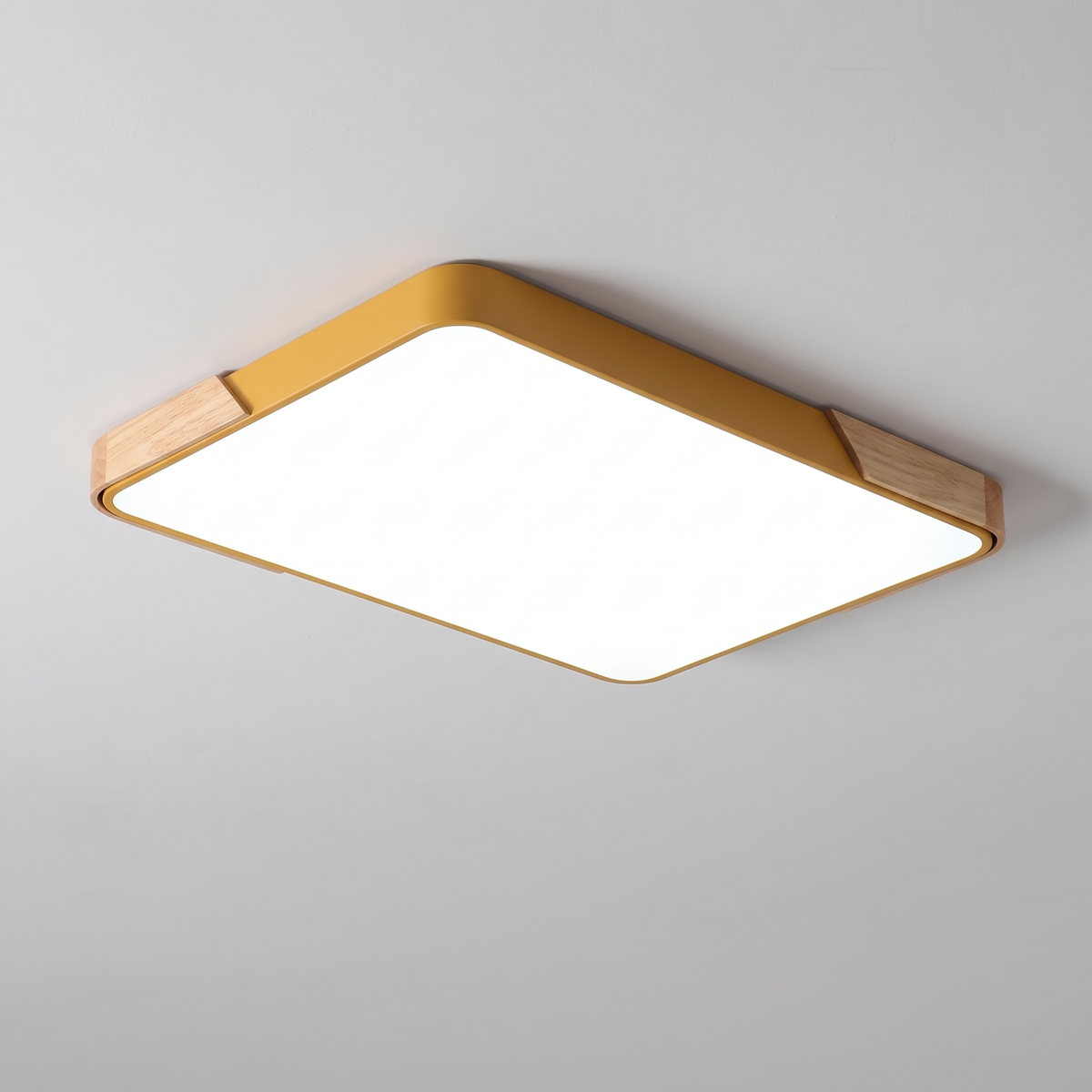 Mavon apricot yellow rectangular slim LED flush mount ceiling light with wood corner trim, fitted flat to a ceiling