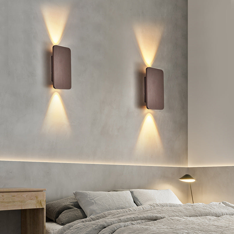 Pair of mazka coffee brown rectangular wall sconces used as ambient bedroom lighting over a bed