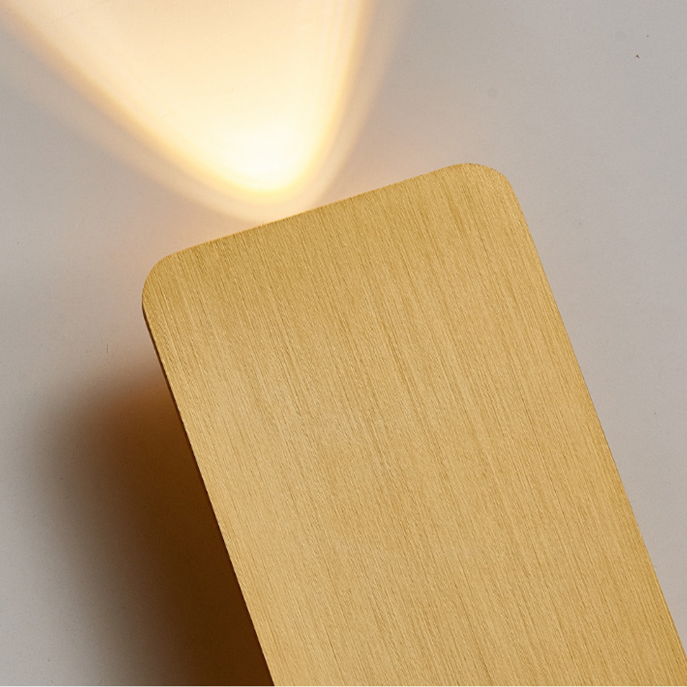 Close-up detail of the premium gold brushed aluminium texture on the flat mazka wall sconce