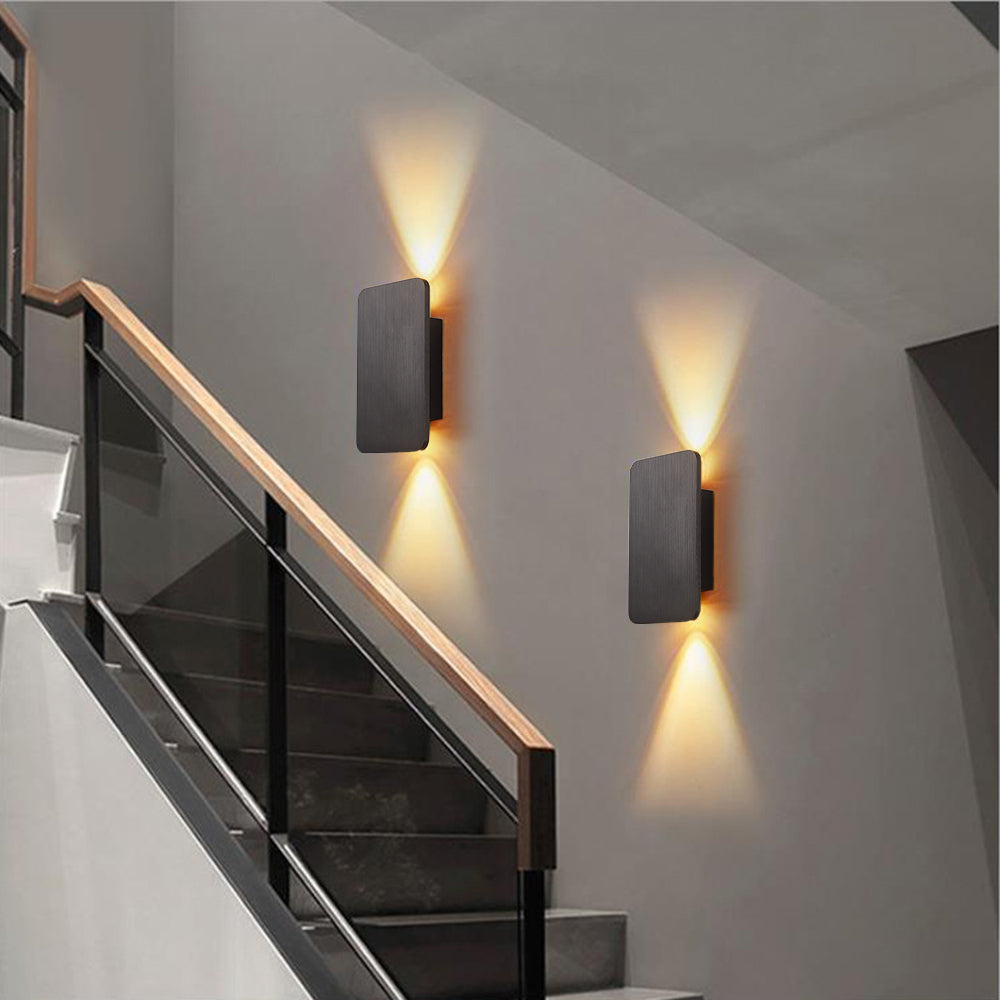 Two grey mazka rectangular LED wall sconces providing elegant architectural lighting up a modern glass staircase