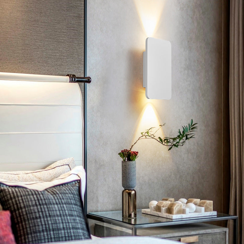 White minimalist mazka rectangular wall lamp acting as a soft ambient bedside light