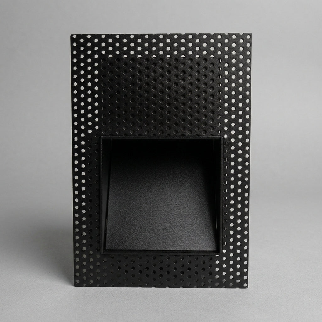 Melte black square perforated recessed LED wall light on a grey studio background