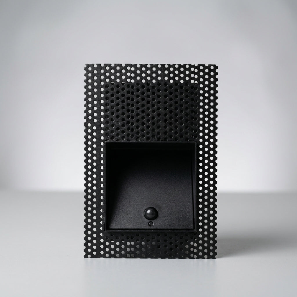 Melte black square perforated recessed LED wall light with a motion sensor, studio view