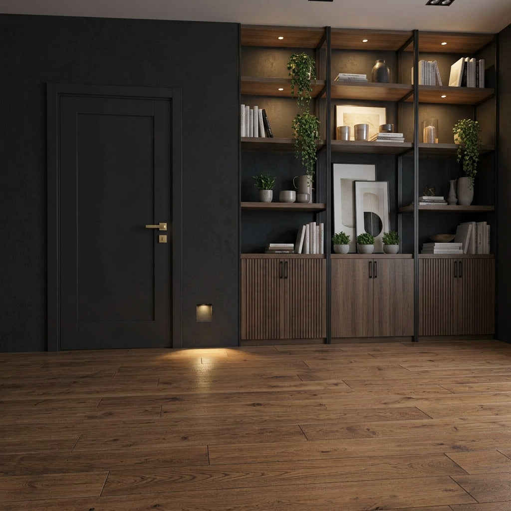 Melte recessed LED wall light low on the wall of a dark hallway with shelving and a wooden floor