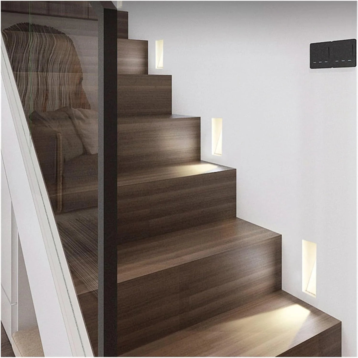 Melte recessed LED wall lights lighting a staircase with a glass balustrade