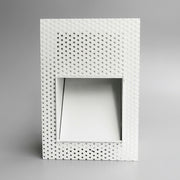 Melte white square perforated recessed LED wall light on a plain grey studio background
