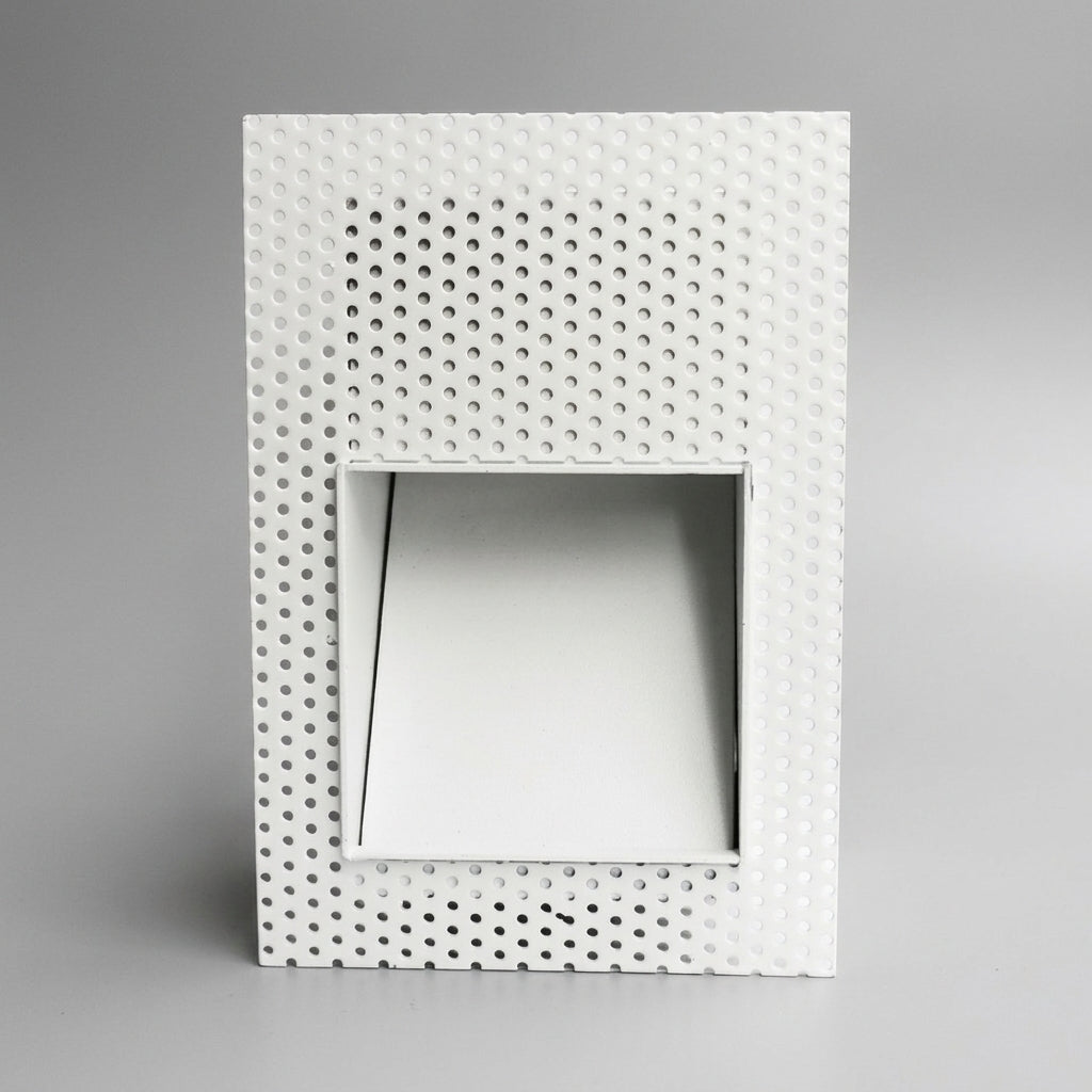 Melte white square perforated recessed LED wall light on a plain grey studio background
