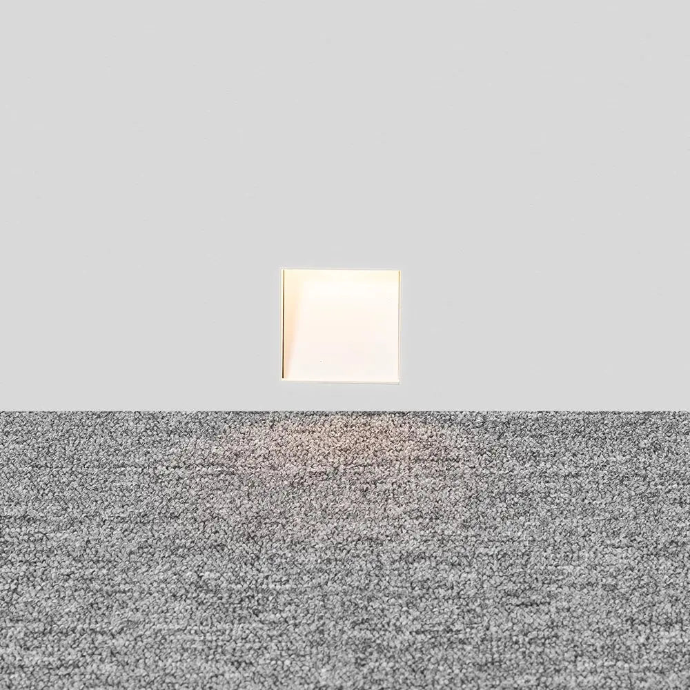 Melte white square recessed LED wall light glowing softly in a grey wall