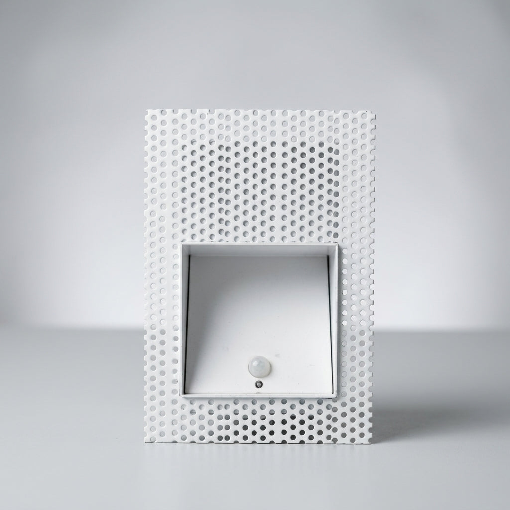 Melte white square perforated recessed LED wall light with a motion sensor, studio view