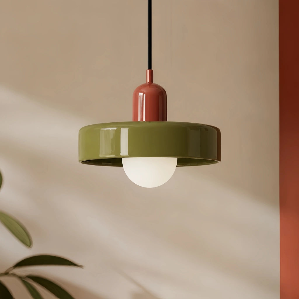Red and green colour-block mera pendant light casting a warm, glare-free glow in a modern interior