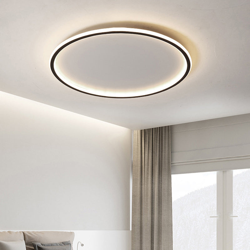 Black halo LED flush mount merqi ceiling light providing a bright ambient glow in a modern bedroom