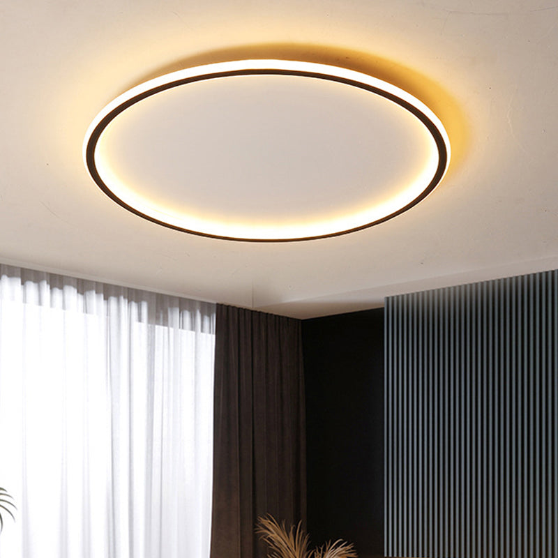 Large black ring merqi ceiling light contrasting beautifully in a contemporary room with dark curtains