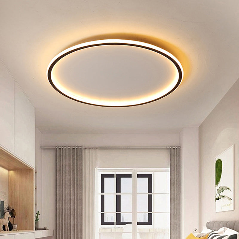 Ultra-thin black halo merqi fixture maintaining a sleek, low profile in a minimalist room