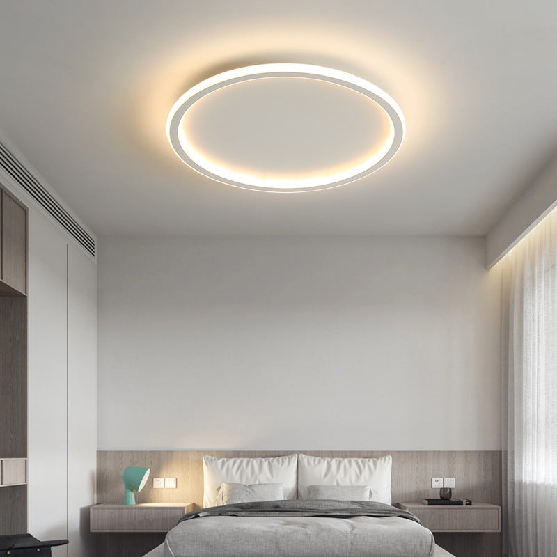 Clean white minimalist ring merqi ceiling lamp casting a smooth, glare-free glow in a bright bedroom