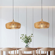 Pair of natural wood Japandi slatted mexi pendant lights suspended over a modern dining table