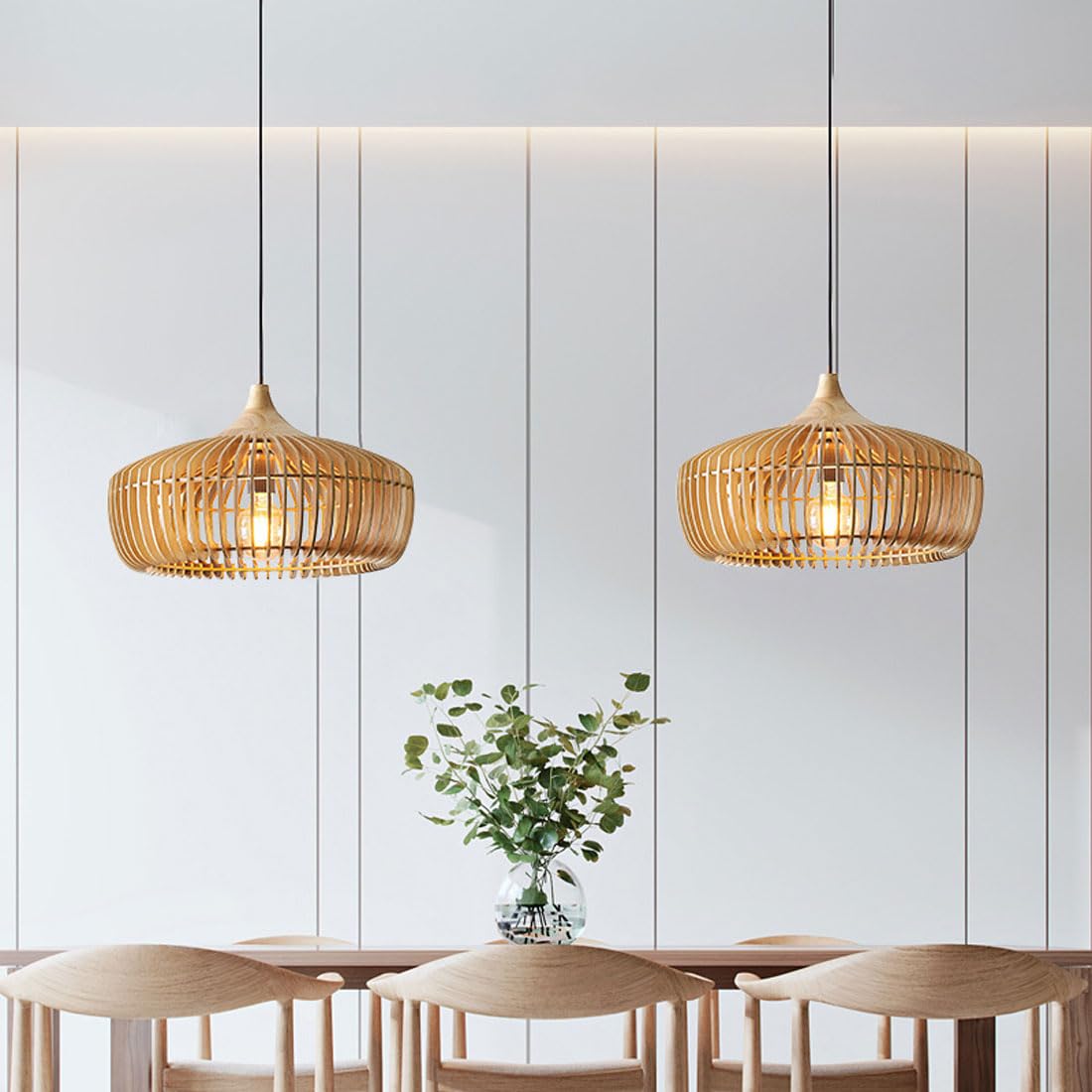 Pair of natural wood Japandi slatted mexi pendant lights suspended over a modern dining table