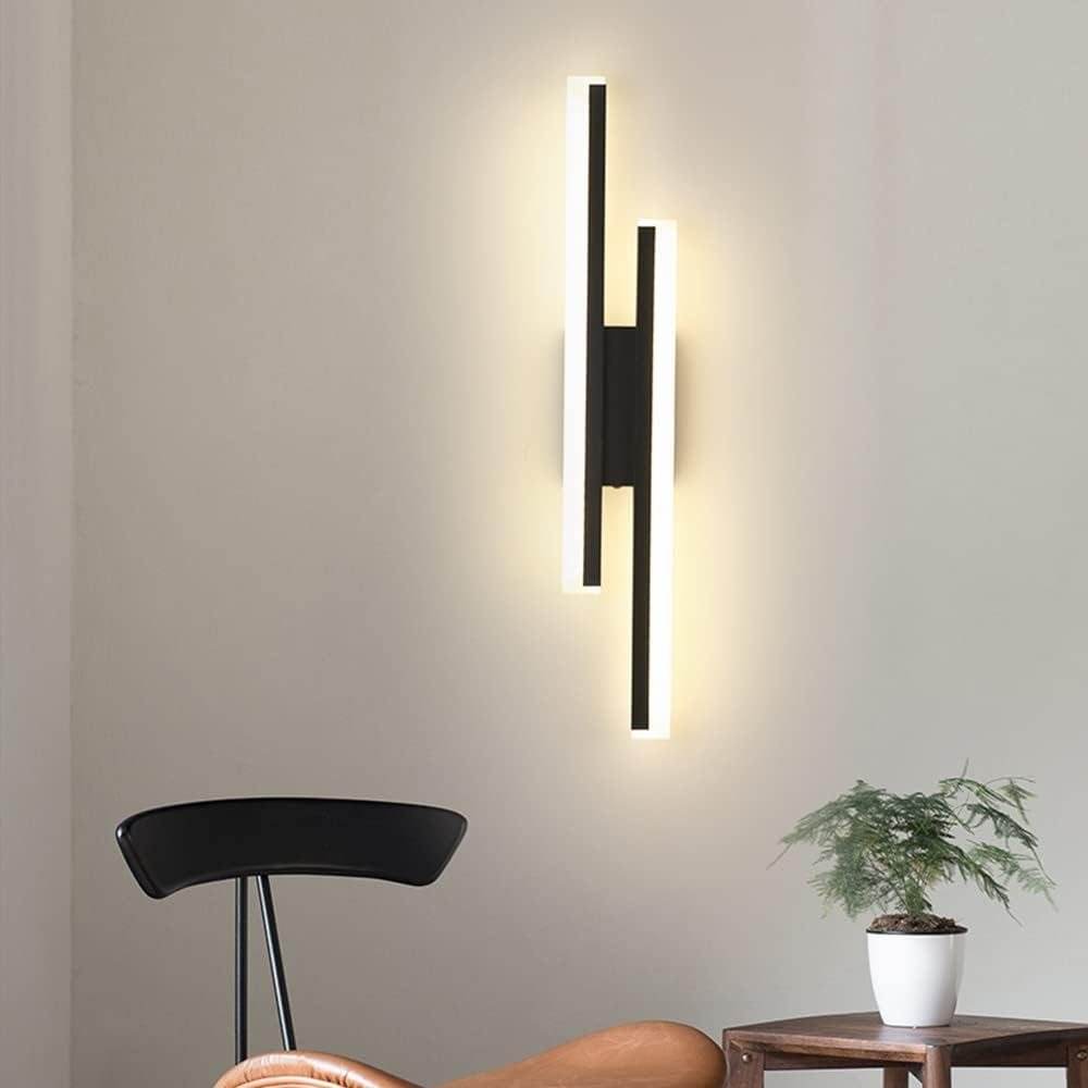 Sleek milor modern black LED wall fixture with glowing acrylic bars casting a warm light against a plain wall