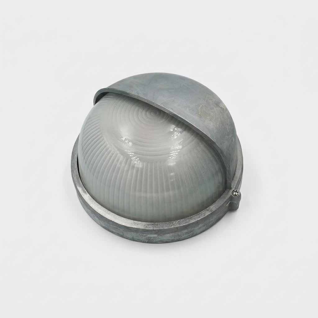 A vintage dome-shaped industrial outdoor wall light fixture with a ribbed translucent glass globe and a weathered grey metal frame, shown on a plain light grey background.