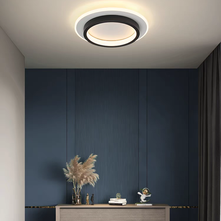 Black round geometric flush mount mura ceiling light illuminating a bedroom with a dark blue accent wall